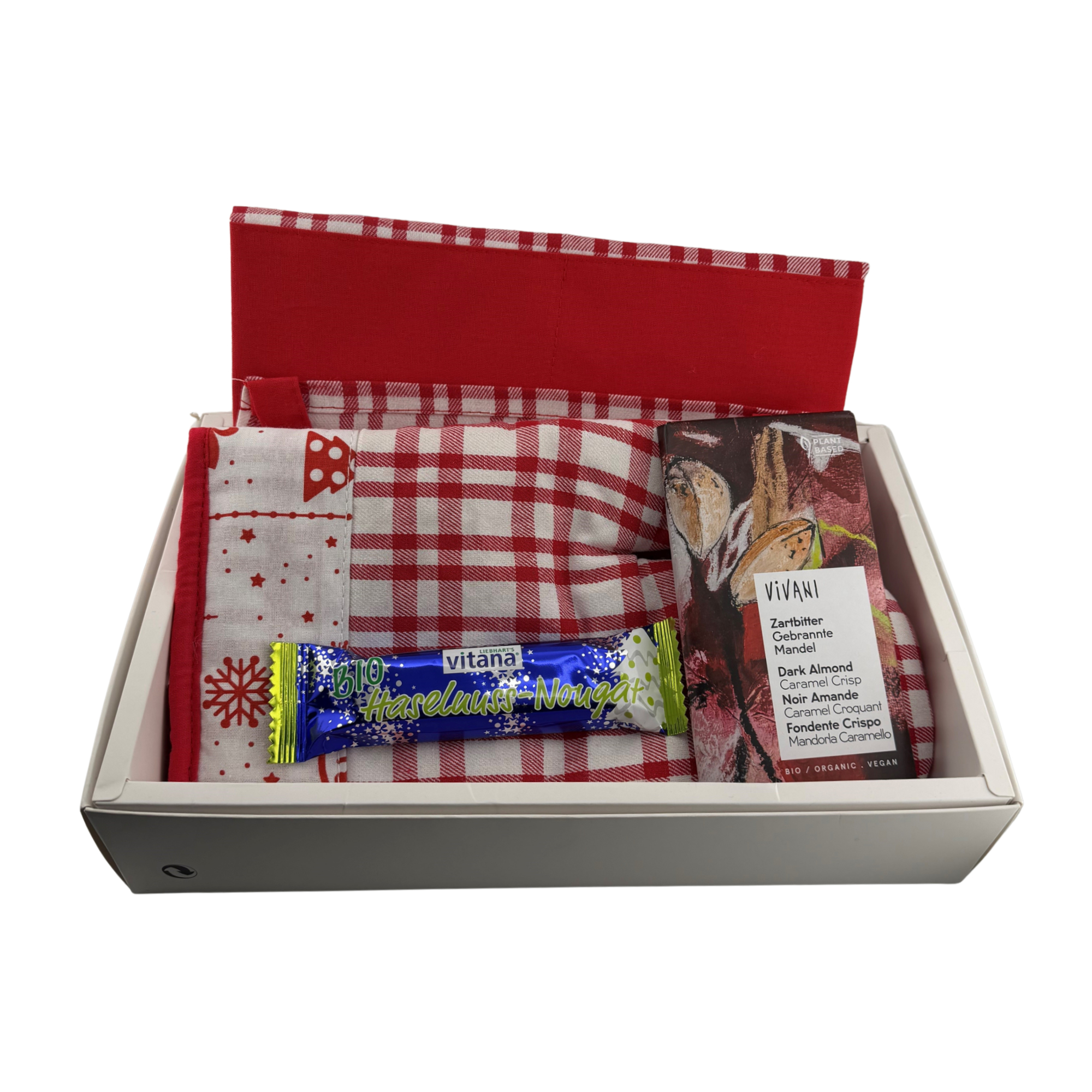 Weihnachten zum heiß anfassen Box BIO - Set aus Küchenschürze und Ofenhandschuh mit weihnachtlichem Muster. 200 g/m² Baumwolle, Liebharts BIO Haselnuss-Riegel in Nougat Schokolade 40g & Vivani BIO Zartbitter Gebrannte Mandel Schokoladentafel 80g